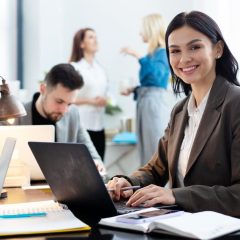medium shot woman working laptop